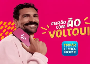 Pessoa sorrindo e segurando o celular, promovendo o Feirão Limpa Nome do Serasa que começa nesta segunda-feira, com oportunidades para regularizar o CPF