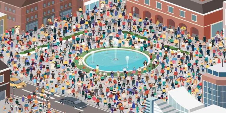 Desafio visual com a multidão reunida em praça urbana com fonte central e edifícios ao redor.