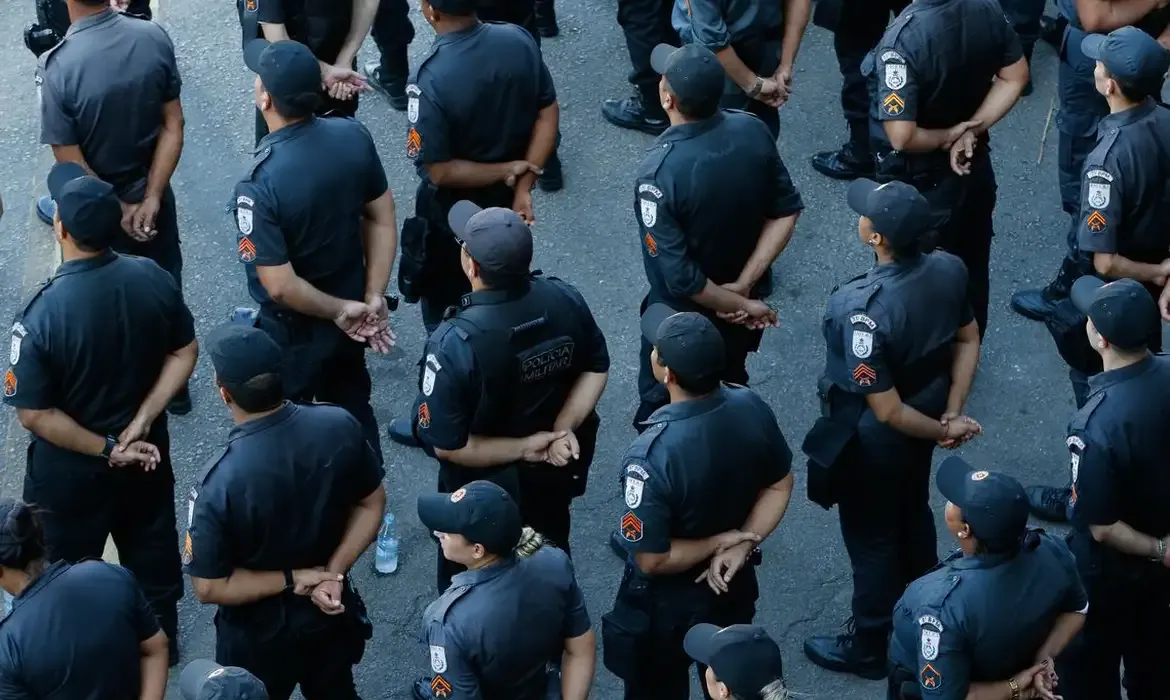 Grupo de policiais militares alinhados em formação.