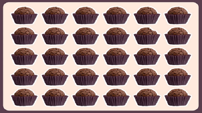 Desafio visual com brigadeiros em forminhas roxas, dispostos em uma grade com um brigadeiro diferente em algum lugar.