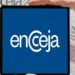 Pessoa segurando tablet com logo do Encceja, ao fundo documentos do exame nacional para jovens e adultos.