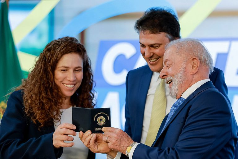 Ministro da Educação, Camilo Santana, e a Ministra da Gestão e da Inovação em Serviços Públicos, Esther Dweck, exibem a carteira de identificação em cerimônia pública.