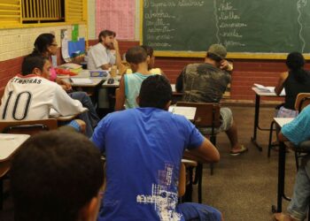 Alunos estudando em sala de aula, representando o público do Encceja, que busca a certificação do Ensino Fundamental ou Médio. A imagem ilustra a preparação para o exame de 2026.