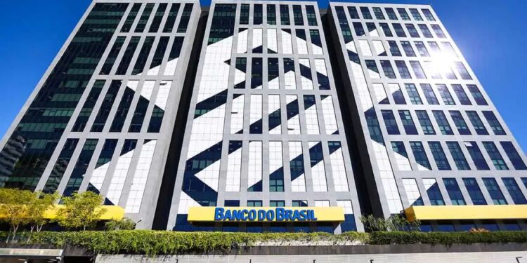 Edifício moderno do Banco do Brasil, com fachada em vidro e o logo da instituição em destaque, representando a sede do banco em preparação para o próximo concurso.