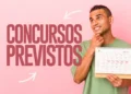 Jovem segurando calendário com datas marcadas sobre fundo rosa e olhando pensativo
