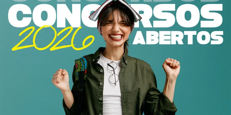 Jovem sorridente com livro aberto na cabeça, jaqueta verde e óculos pendurados, celebrando concursos 2026